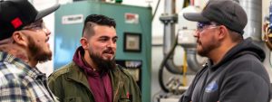 HVAC students in training discussing equipment, Su’Coy Community Learning Center Maryland.