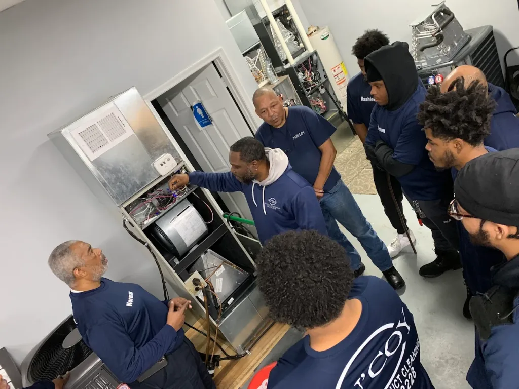 Su&rsquo;Coy CLC instructor demonstrating a furnace to a group of HVAC students in the Temple Hills lab